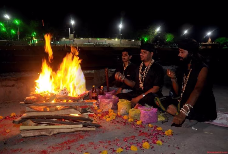 Three sadhakas sit beside a powerful nighttime fire ritual with offerings and flowers, reflecting the strict caution needed in intense tantric sadhana where errors or harmful intent can disturb the seeker’s life.